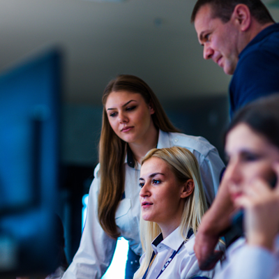 team collaborating in an office discussing strategies for project